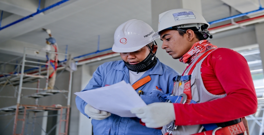 Construction workers discussing a project onsite